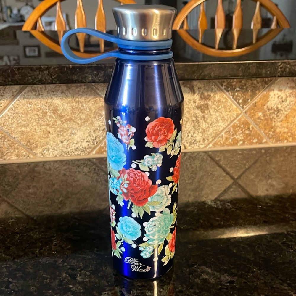 The pioneer woman stainless steel water bottle. 10in tall and holds up to 18 oz.